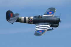 Grahame Pearson’s Black Horse Hawker Typhoon Maiden, taking to the skies over Coombes on 29th June 2025. Although the model has flown several years ago this was essentially a maiden flight. It flew very well feeling rock solid in the air. The 79” model has been enhanced with some airbrush applied weathering. Model weighs 7kg and is powered by a Saito 220 (36cc) 4-stroke turning a 20x6 Master Airscrew prop. Photo by Jaime Brazier