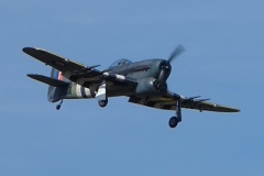 Grahame Pearson’s Black Horse Hawker Typhoon Maiden, taking to the skies over Coombes on 29th June 2025. Although the model has flown several years ago this was essentially a maiden flight. It flew very well feeling rock solid in the air. The 79” model has been enhanced with some airbrush applied weathering. Model weighs 7kg and is powered by a Saito 220 (36cc) 4-stroke turning a 20x6 Master Airscrew prop. Photo by Jaime Brazier