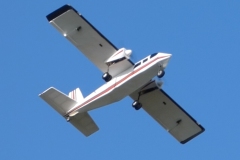 John Wase flies his Britten-Norman Islander on a summer evening. Model was built from an American plan designed by Bud Chappel, 60” wingspan, covered in Oratex. Power is by two 3530 1100kV motors swinging 9x4” counter-rotating props. Two 30A ESCs fed by a 4S 4000 LiPo. Photo by Grahame Pearson, August 2025