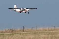 John Wase flies his Britten-Norman Islander on a summer evening. Model was built from an American plan designed by Bud Chappel, 60” wingspan, covered in Oratex. Power is by two 3530 1100kV motors swinging 9x4” counter-rotating props. Two 30A ESCs fed by a 4S 4000 LiPo. Photo by Grahame Pearson, August 2025